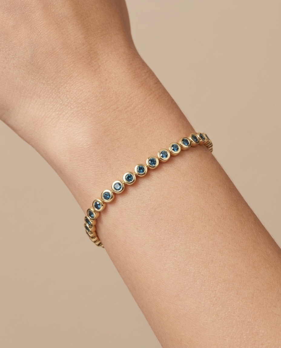 14KT Yellow Gold Blue Diamond Bezel Tennis Bracelet on model