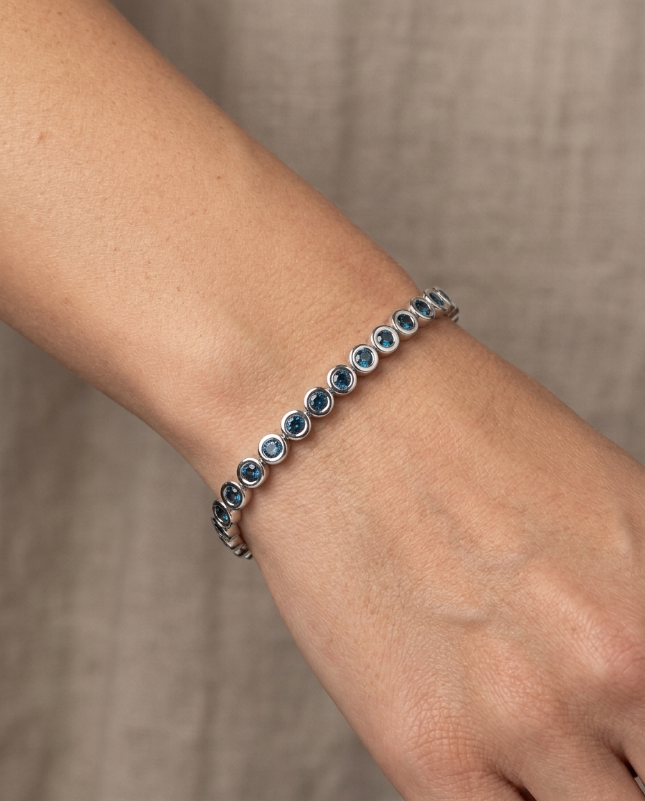 14KT White Gold Blue Diamond Bezel Tennis Bracelet on model