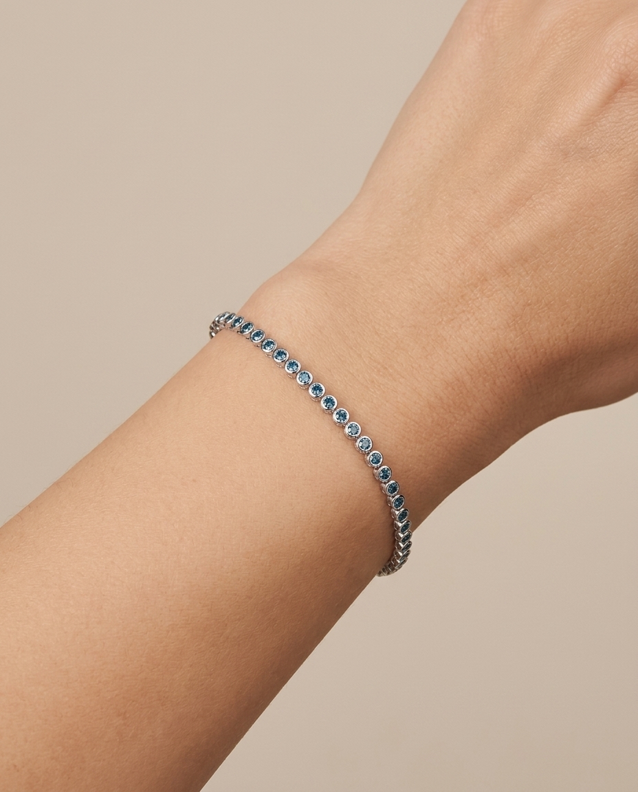 14KT White Gold Blue Diamond Bezel Tennis Bracelet on model
