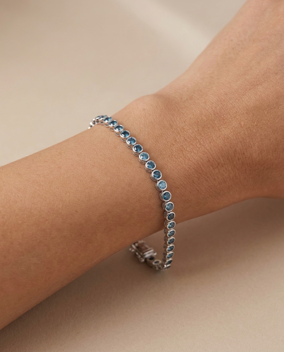 14KT White Gold Blue Diamond Bezel Tennis Bracelet on model