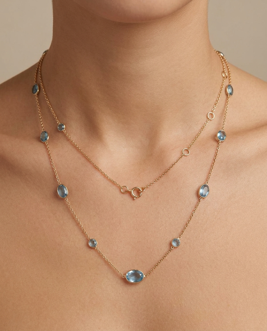 18KT Yellow Gold Gold Bezeled London Blue Topaz Oval Station Necklace on model
