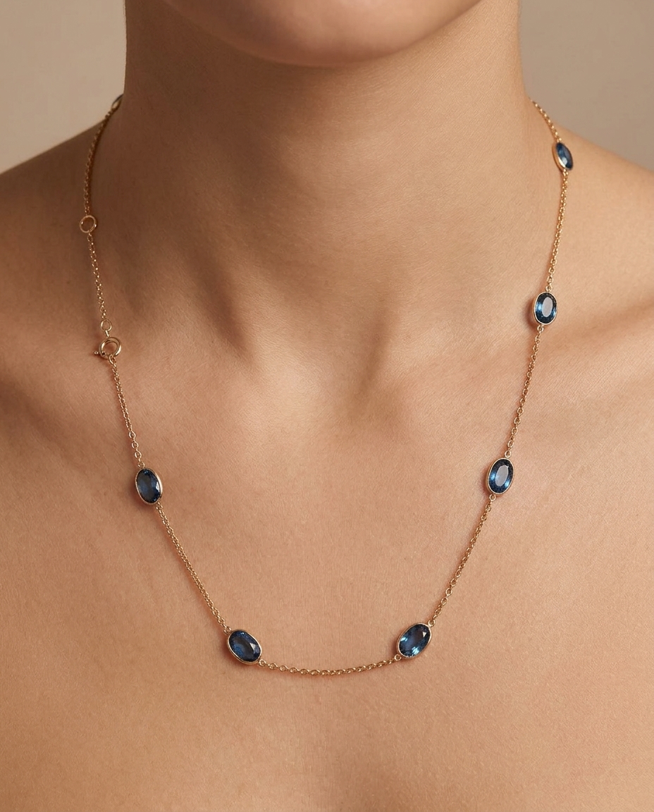 18KT Yellow Gold Gold Bezeled London Blue Topaz Oval Station Necklace on model
