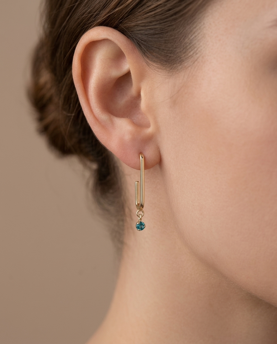 14KT Yellow Gold Huggie with Hanging Emerald Earring on model