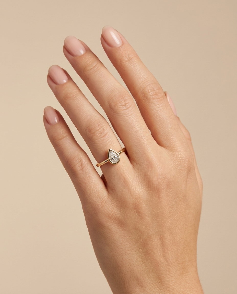 14KT Gold Ring with Single Bezeled Pear Shape Diamond on model