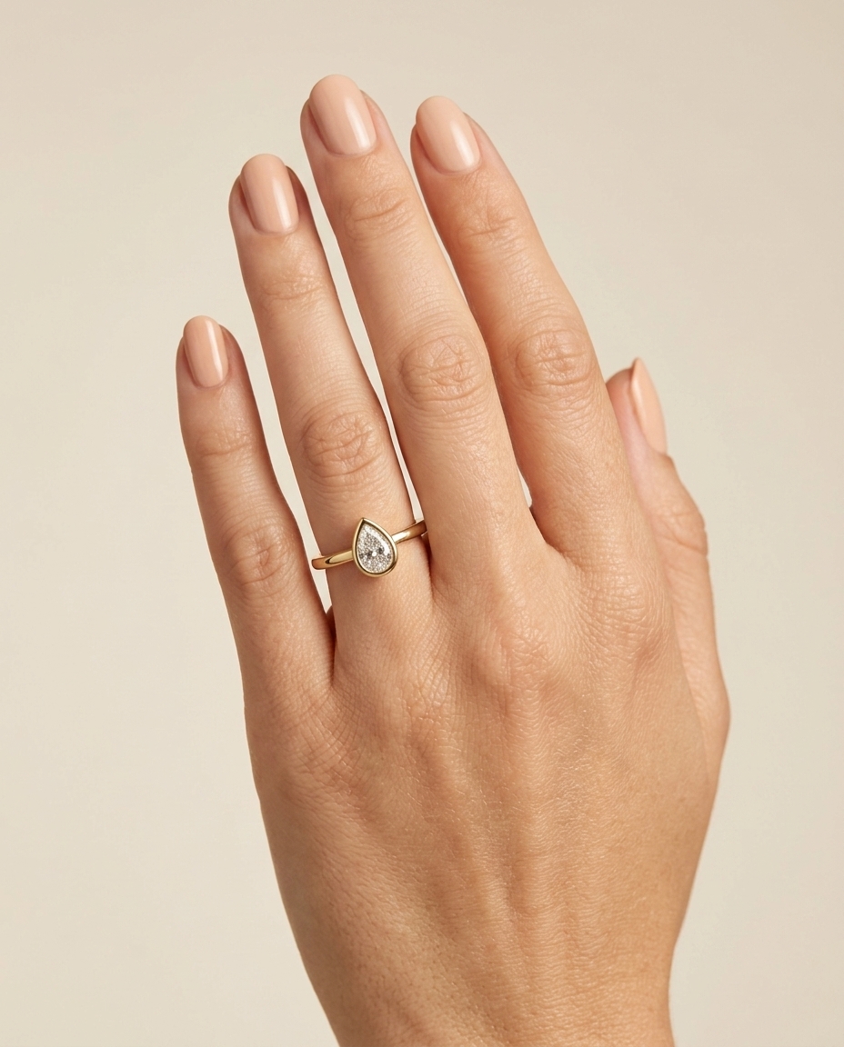14KT Gold Ring with Single Bezeled Pear Shape Diamond on model