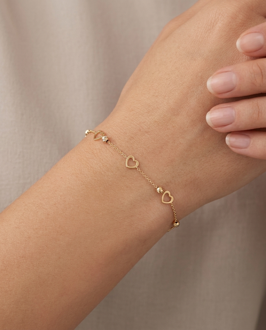 14KT Gold Heart Ball Braclet on model