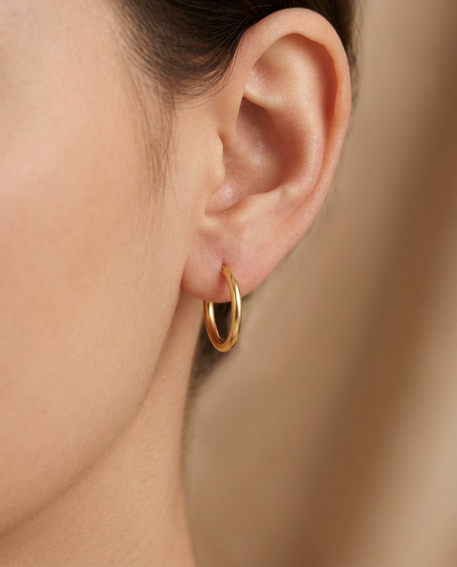 Plain Thin Huggies Earring in Yellow Gold on model