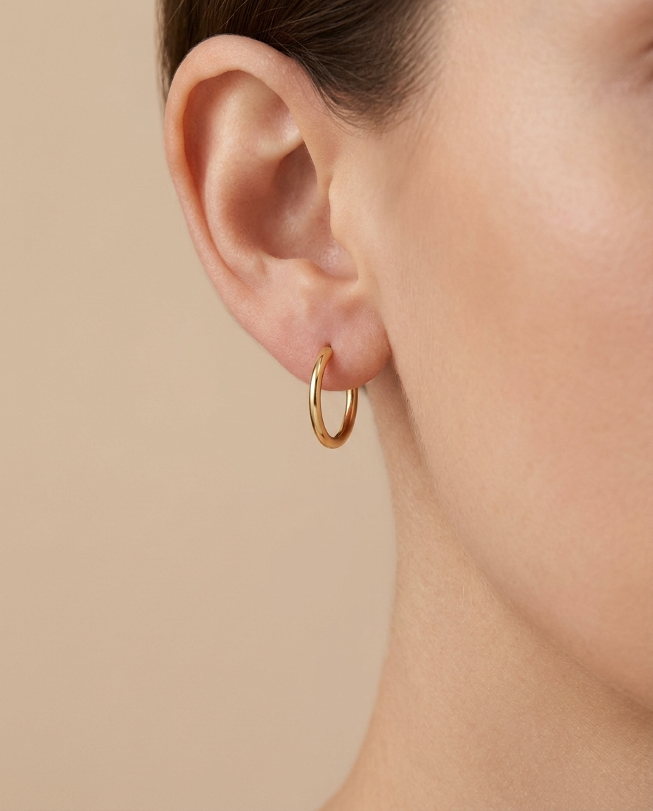 Plain Thin Huggies Earring in Yellow Gold on model
