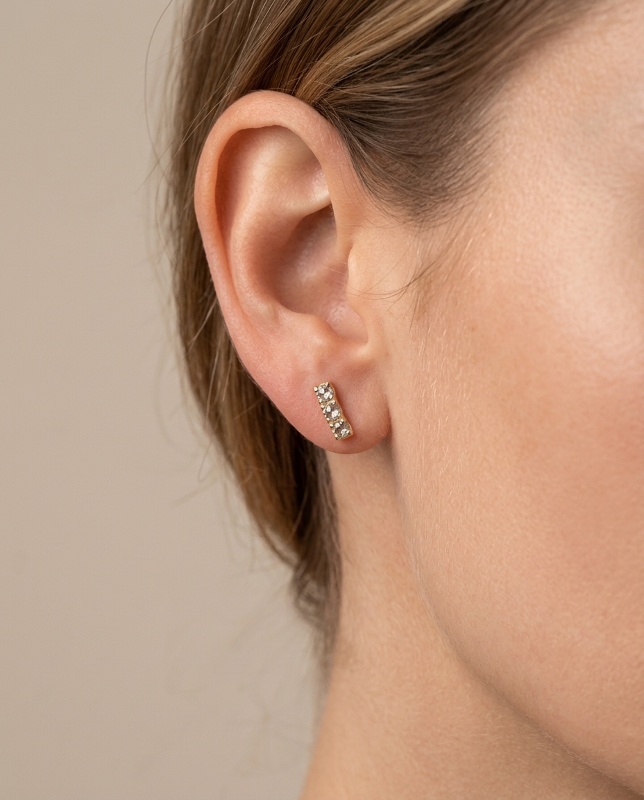 Diamond Curved Bar Stud . in Yellow Gold on model