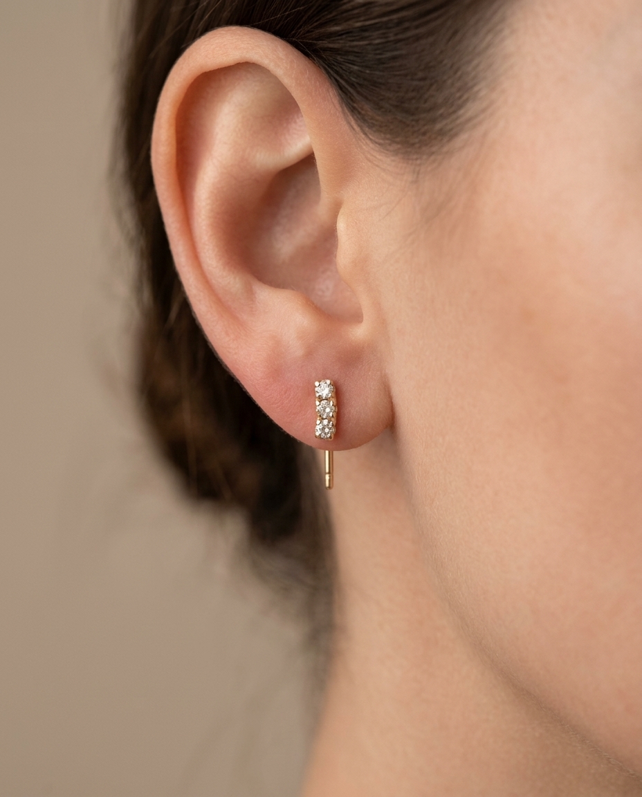 Diamond Curved Bar Stud . in Yellow Gold on model